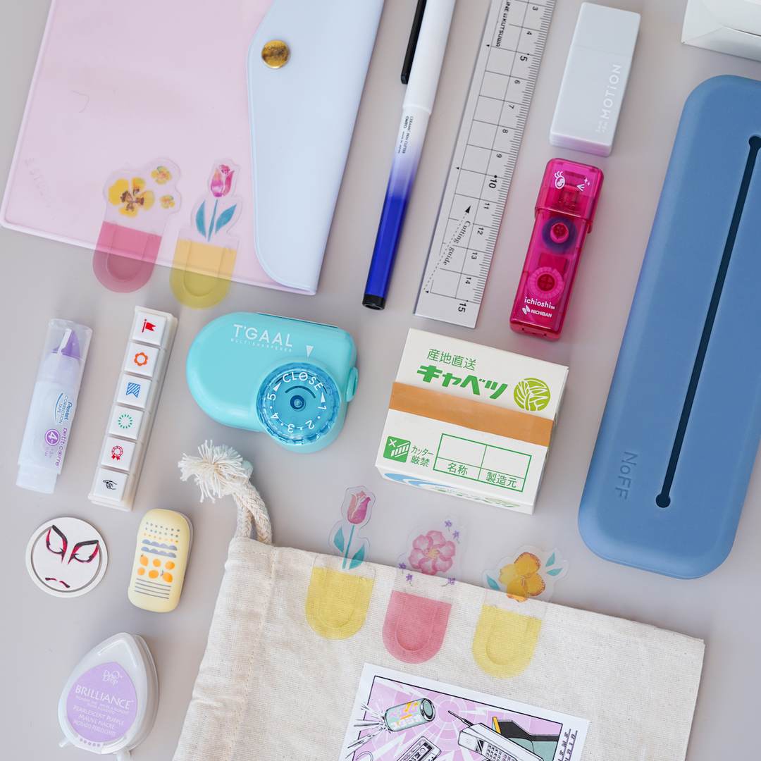 Stationery essentials items laid out on a table surface